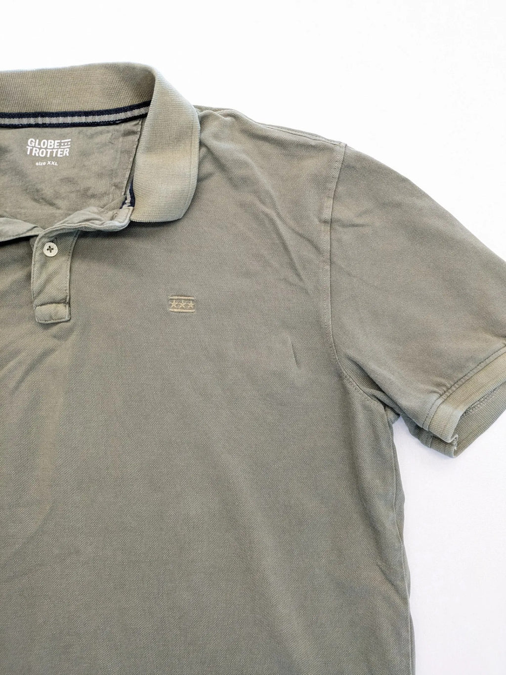 Globe-Trotter beige khaki polo shirt with classic collar and small chest logo.