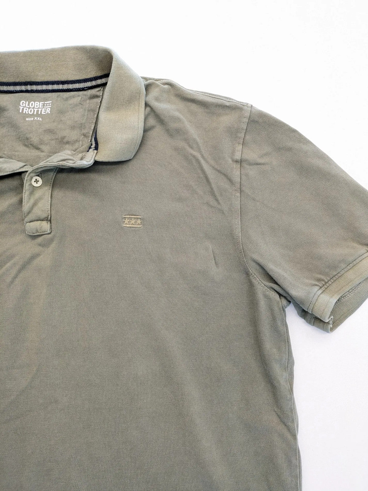 Globe-Trotter beige khaki polo shirt with classic collar and small chest logo.
