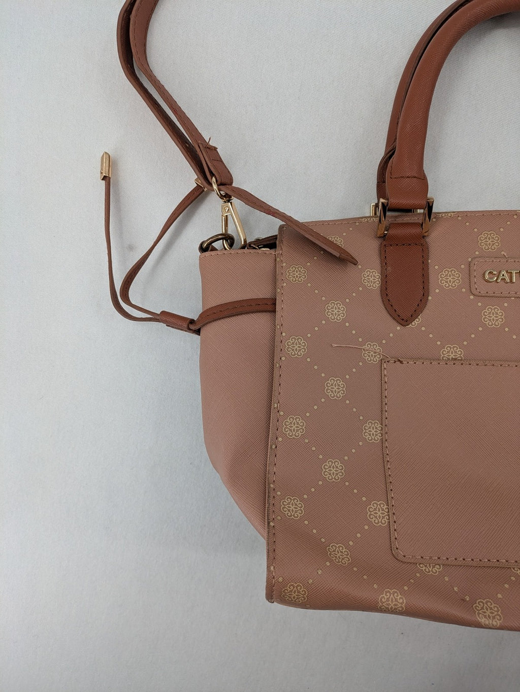 Catwalk gold handbag with pink and brown monogram pattern, adjustable shoulder strap.
