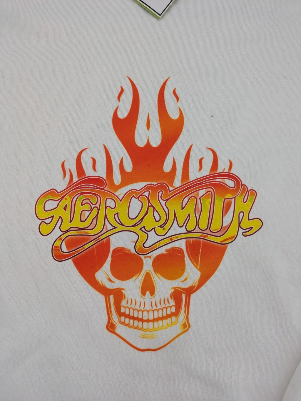 Aerosmith white sweatshirt with bold front graphic, logo, and flaming skull design.
