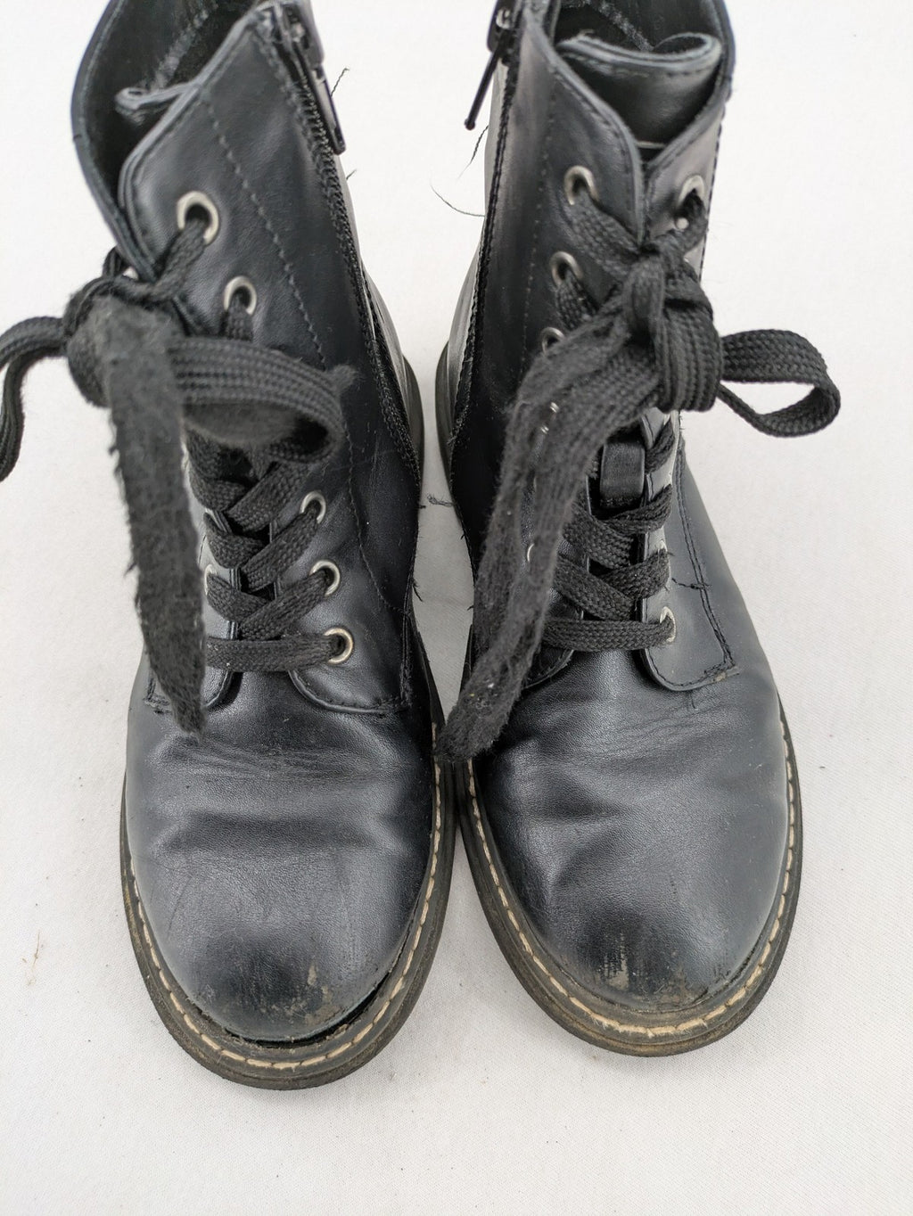 Esprit black combat boots for girls with lace-up front and side zipper detail.
