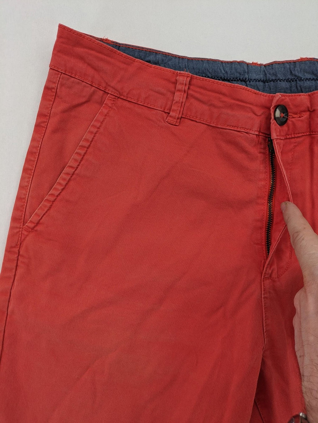 Chino orange shorts flat front with Est. 1921 label and comfortable fit.