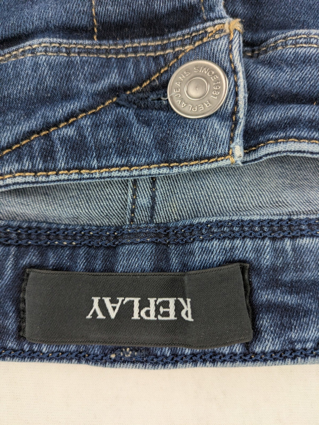Replay slim fit jeans blue with subtle fading and stretch denim material.