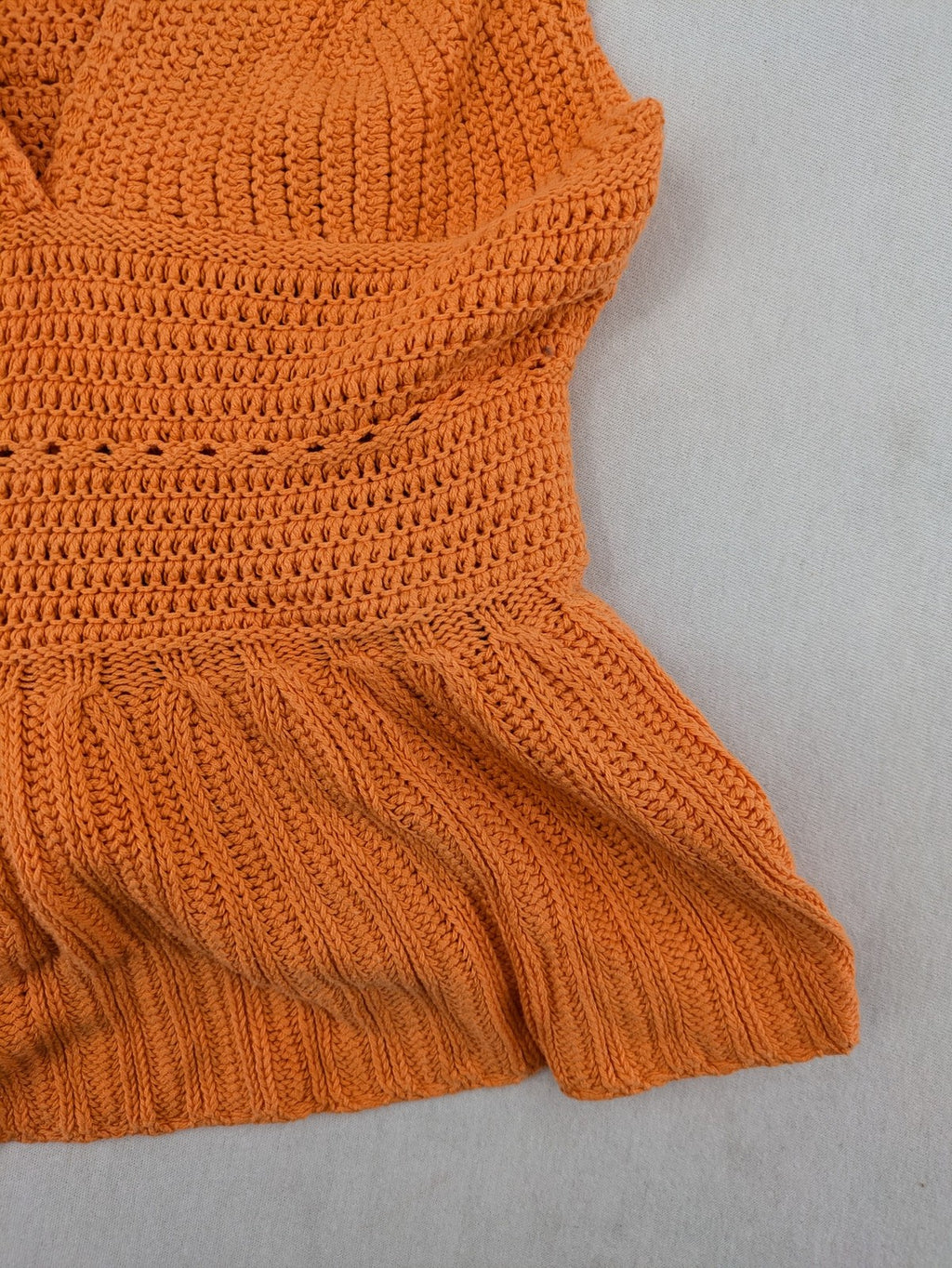 REVIEW orange crochet top with V-neck and peplum hem, made from 100% cotton.