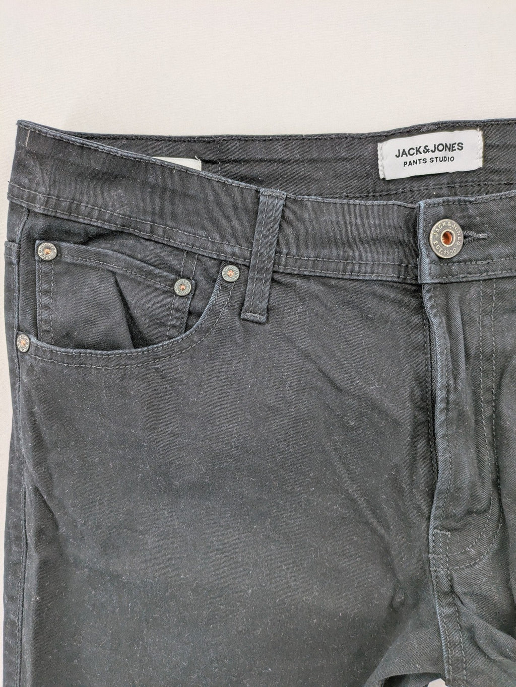 Jack & Jones black slim fit jeans with logo patch and cotton-stretch blend.