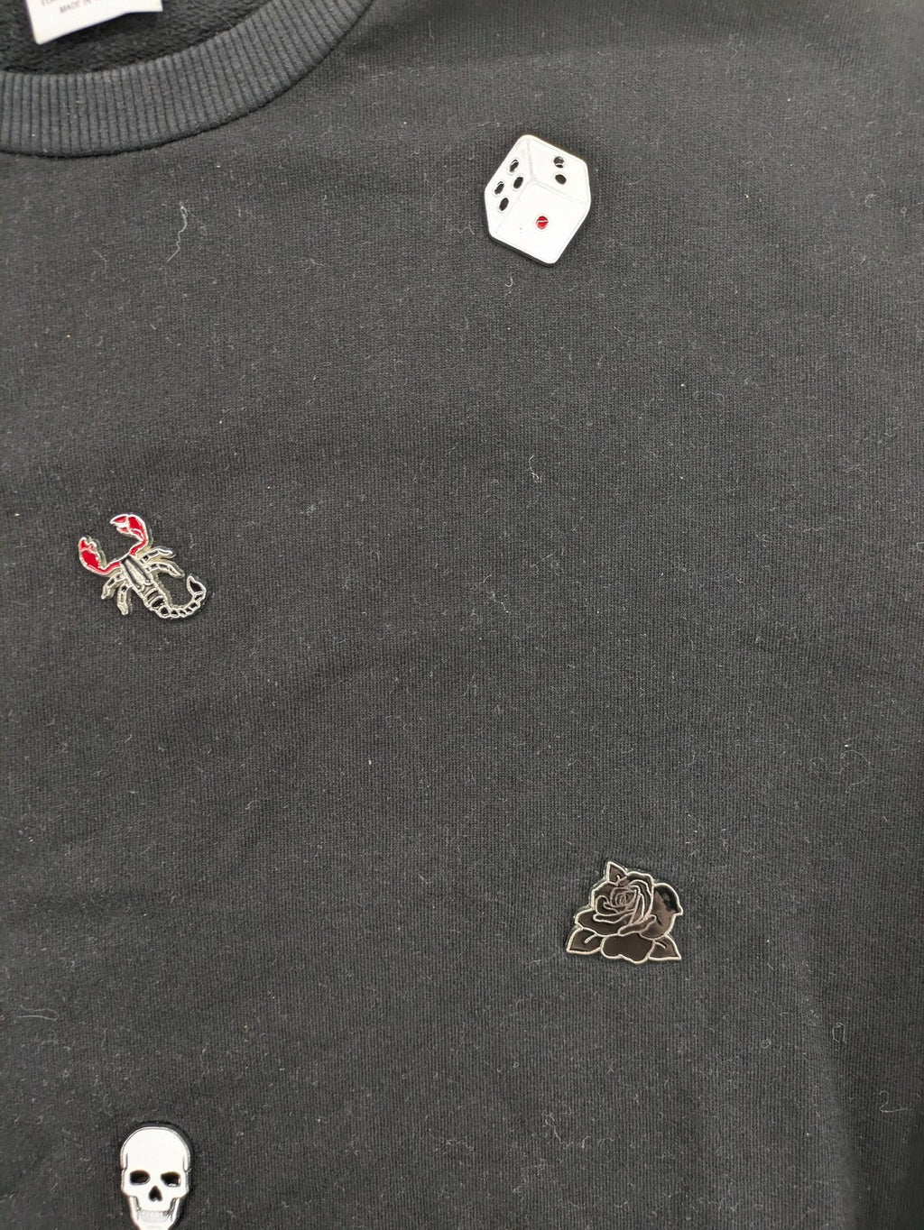 Zara grey turtle neck jumper with skull, scorpion, flame, and eagle embellishments.