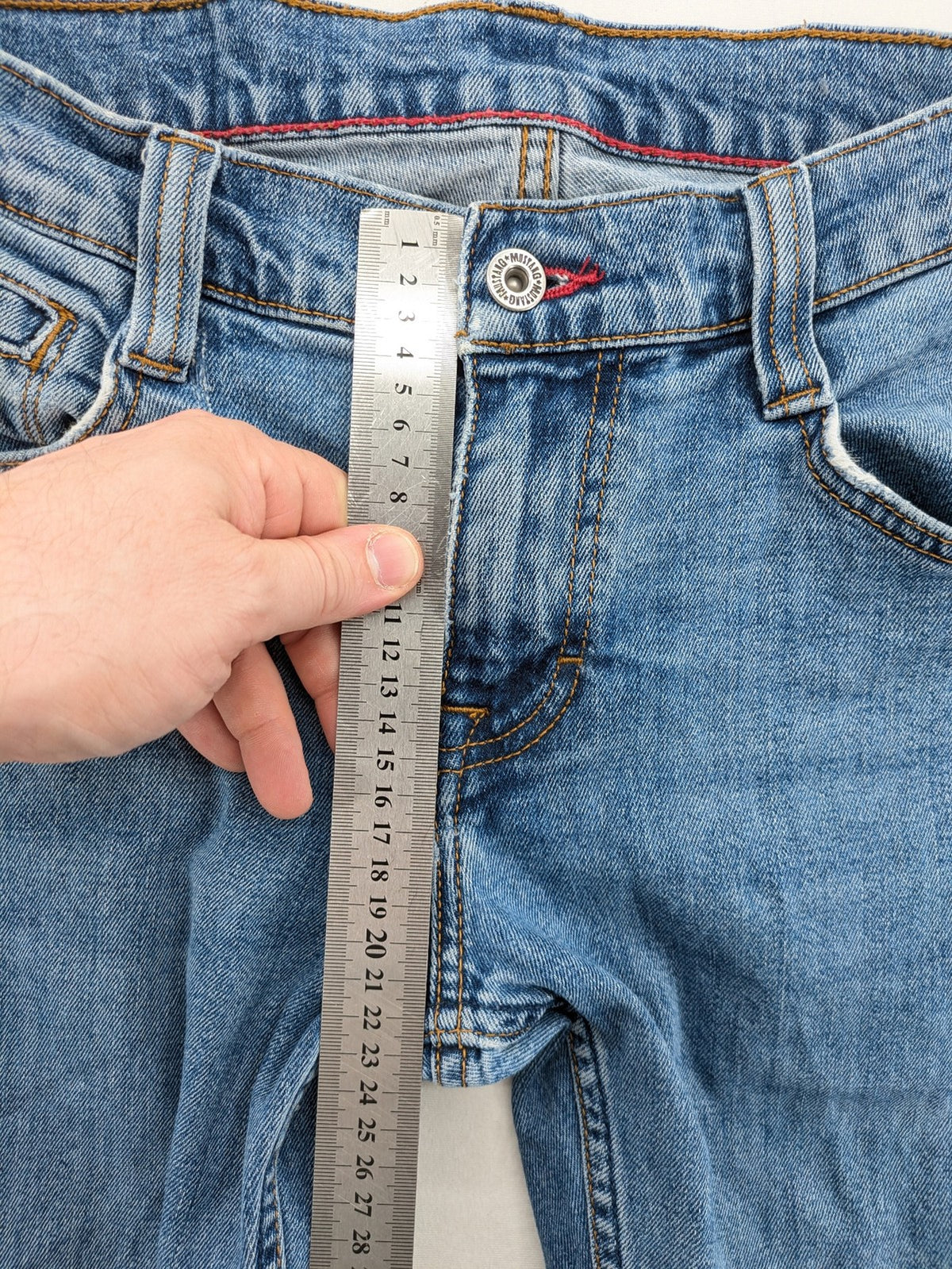 Mustang blue straight jeans with classic wash and durable denim material.