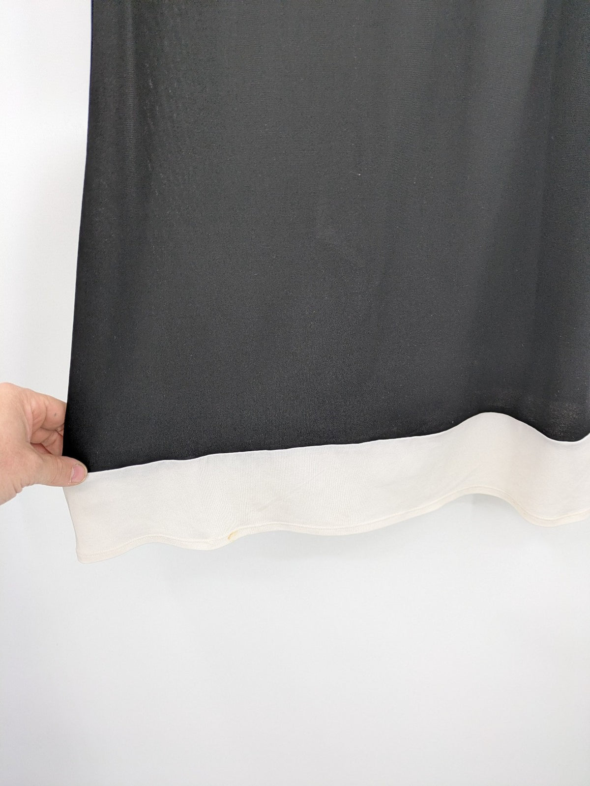 En Focus Studio beige and black top, sleeveless with beaded neckline and tie detail.