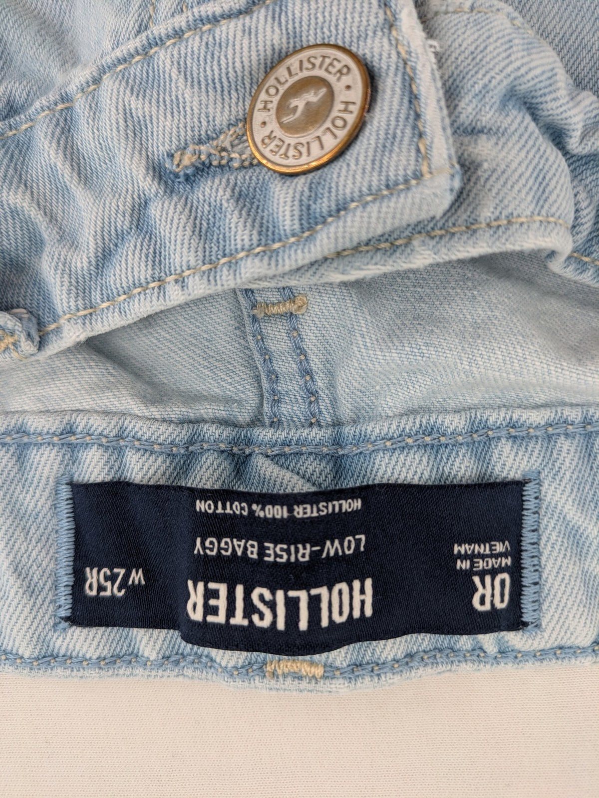 Hollister blue straight jeans low-rise baggy with raw hem and classic five-pocket design.