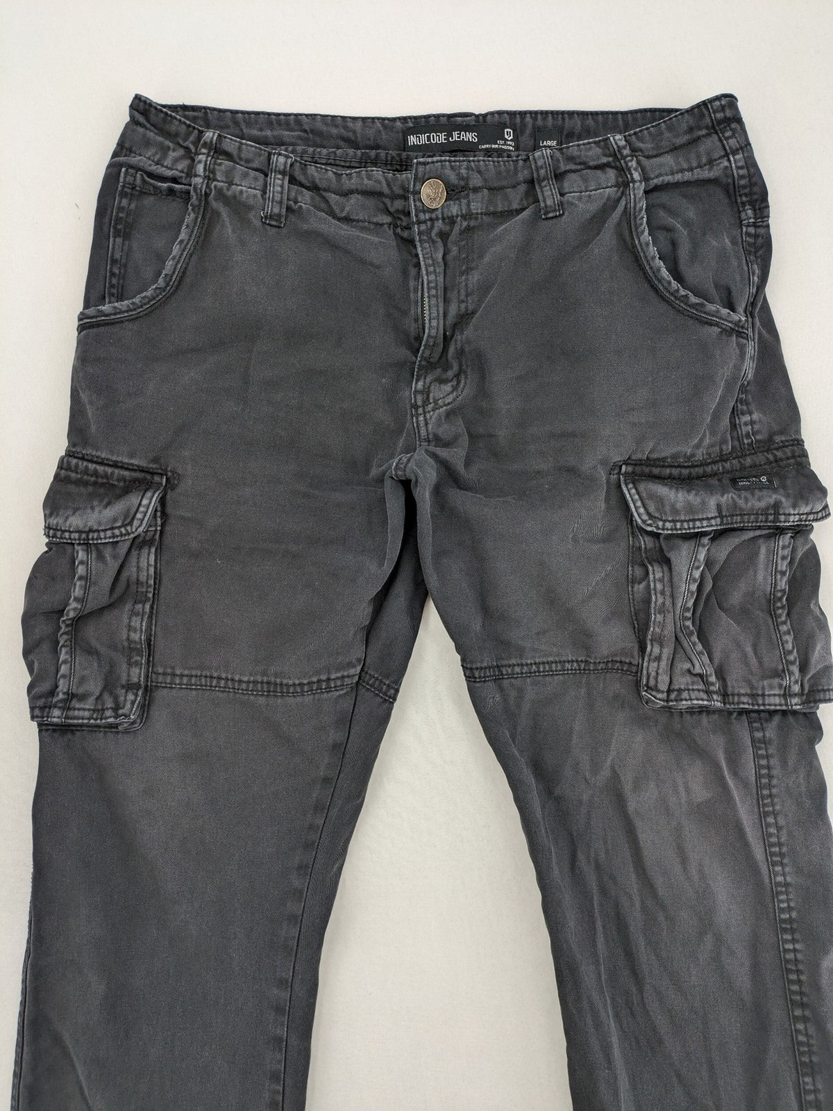 Indicode grey cargo pants with multiple pockets and durable cotton material.