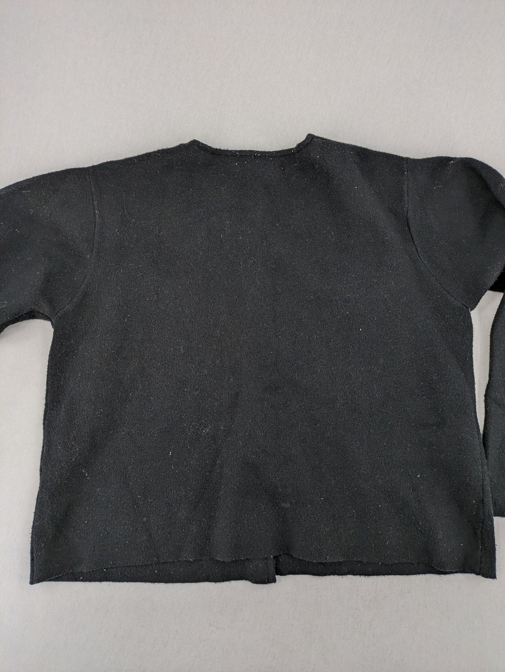 Reserved gold turtle neck jumper with black knit, gold button details and front pockets.