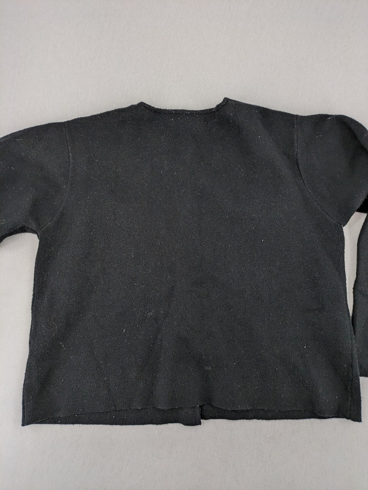 Reserved gold turtle neck jumper with black knit, gold button details and front pockets.