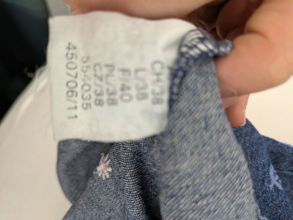 Damen blue denim mini dress with all-over white and light blue floral embroidery.