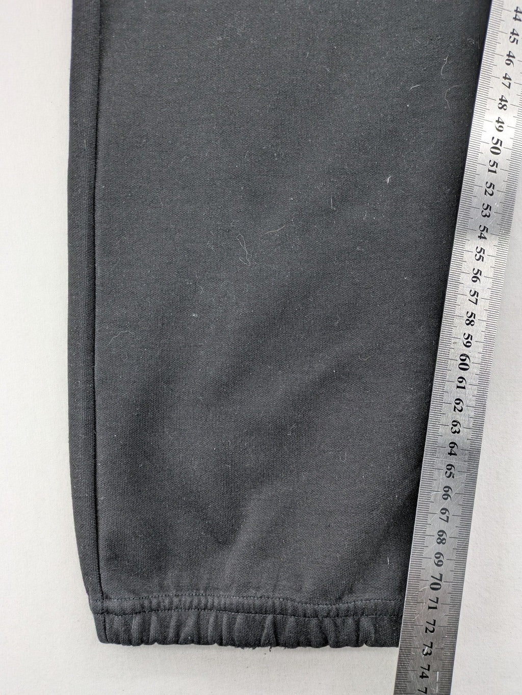 K1X grey joggers with white basketball logo, elastic waistband, and cuffed ankles.