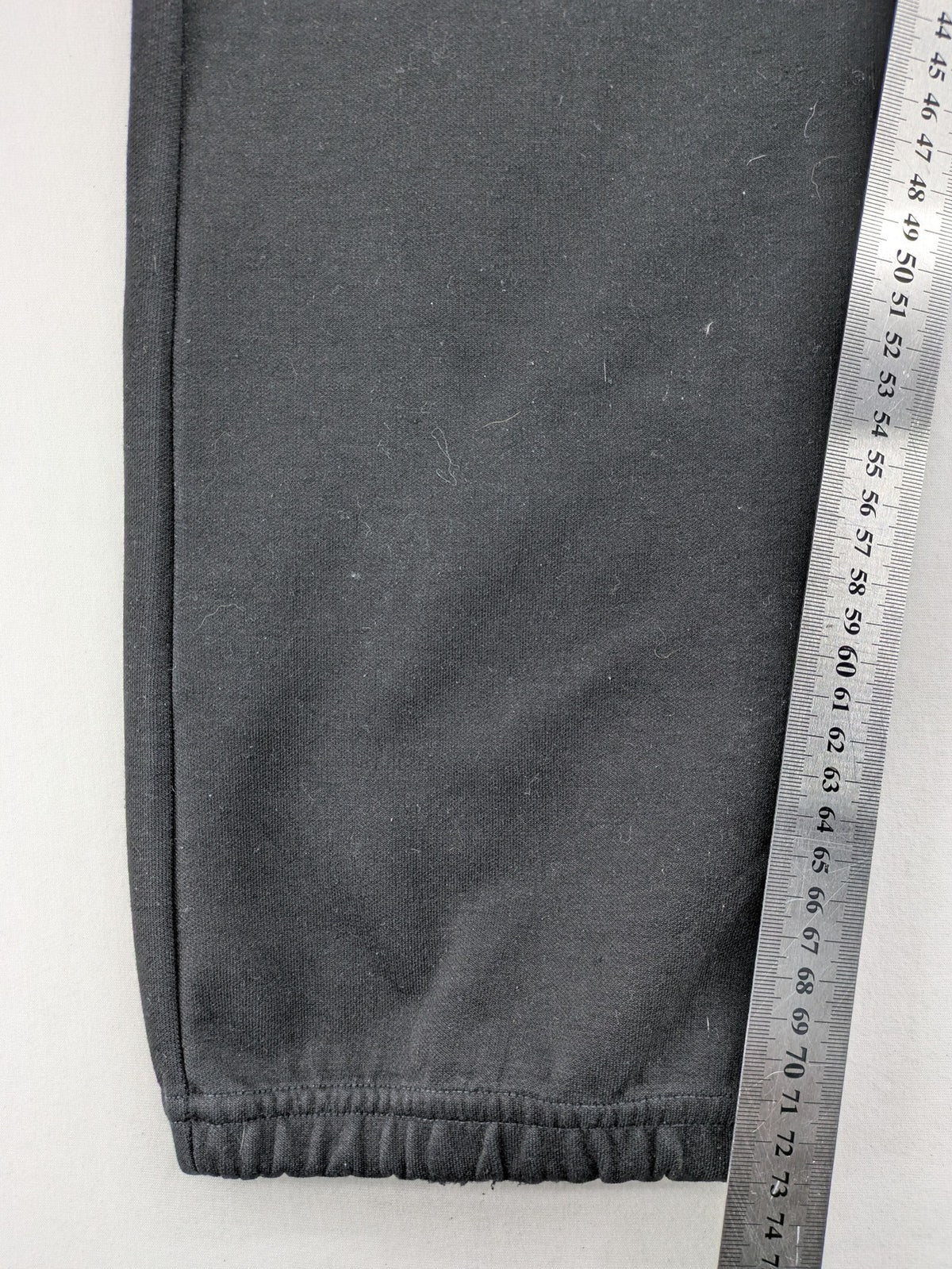 K1X grey joggers with white basketball logo, elastic waistband, and cuffed ankles.