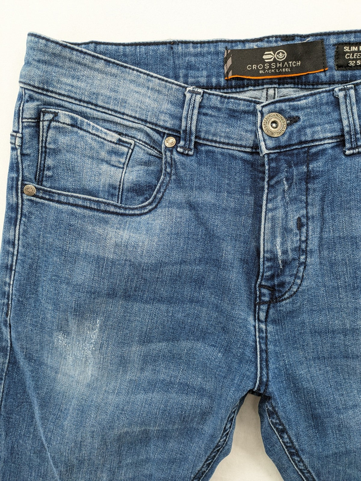 Crosshatch blue slim fit jeans with faded wash and logo patch on back pocket.