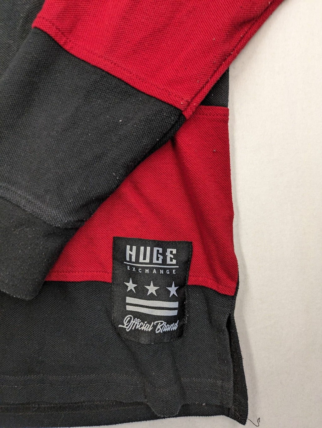 Huge Fashion Exchange rugby polo shirt red and black striped with "SUPERB" graphic.