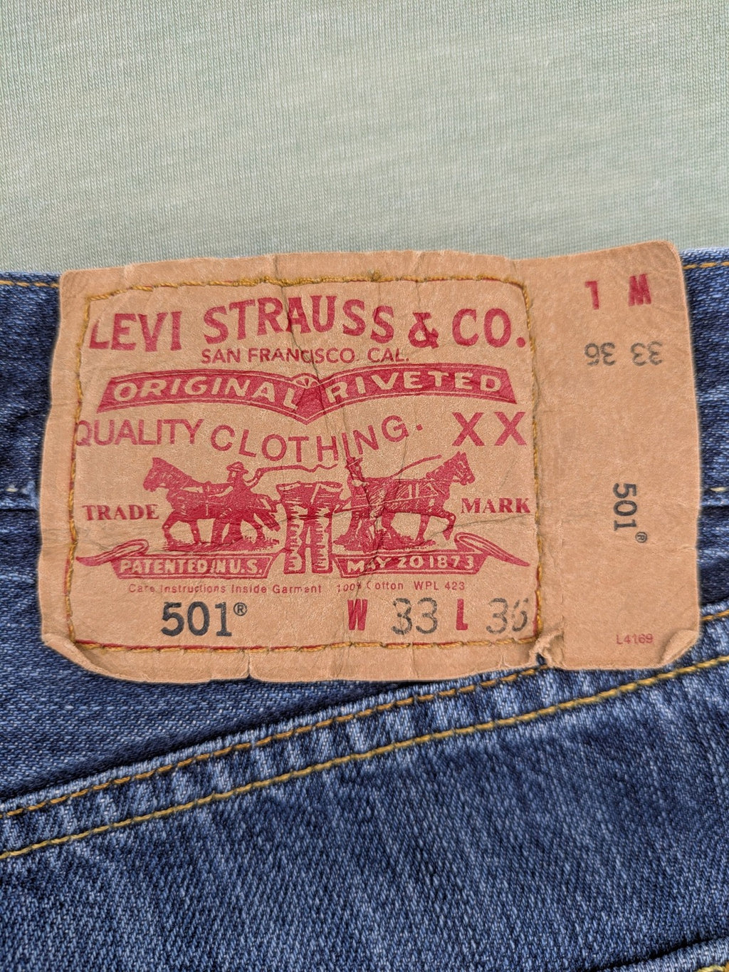 Levi's blue cut-off shorts with frayed hem, classic 5-pocket design, button fly.