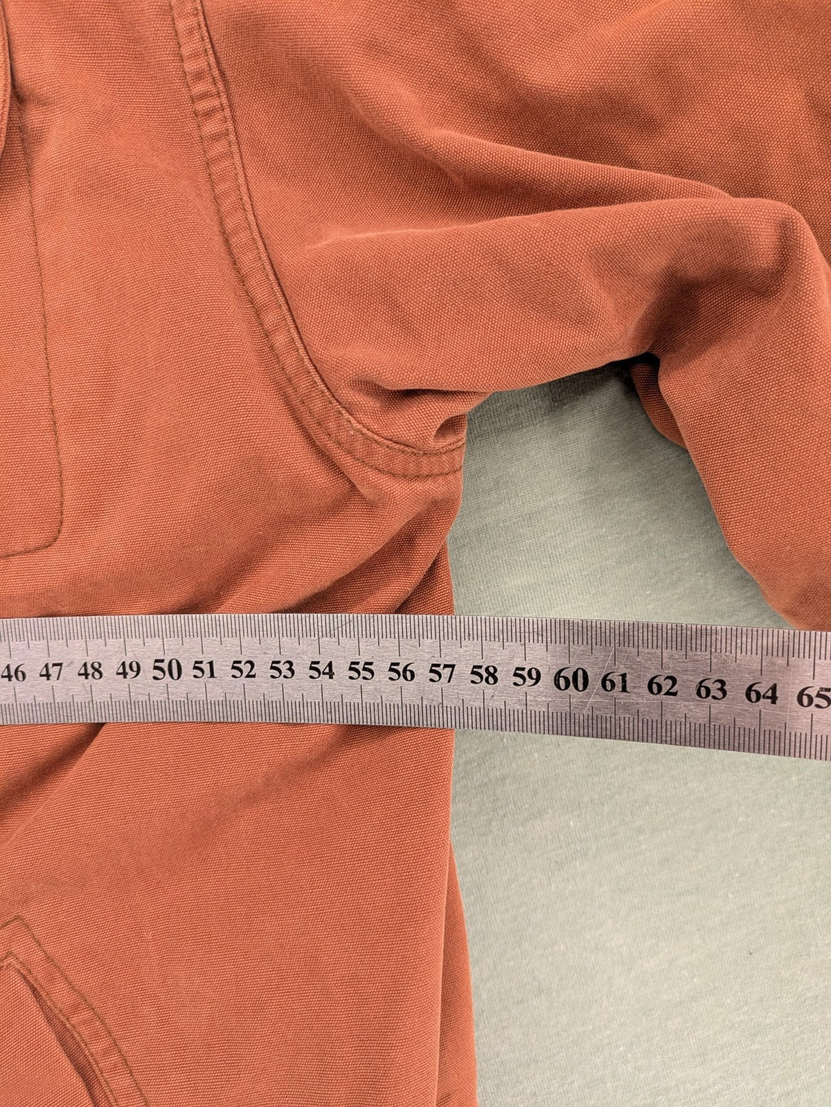 Camel Collection brown jacket with orange contrast collar and embroidered logo.