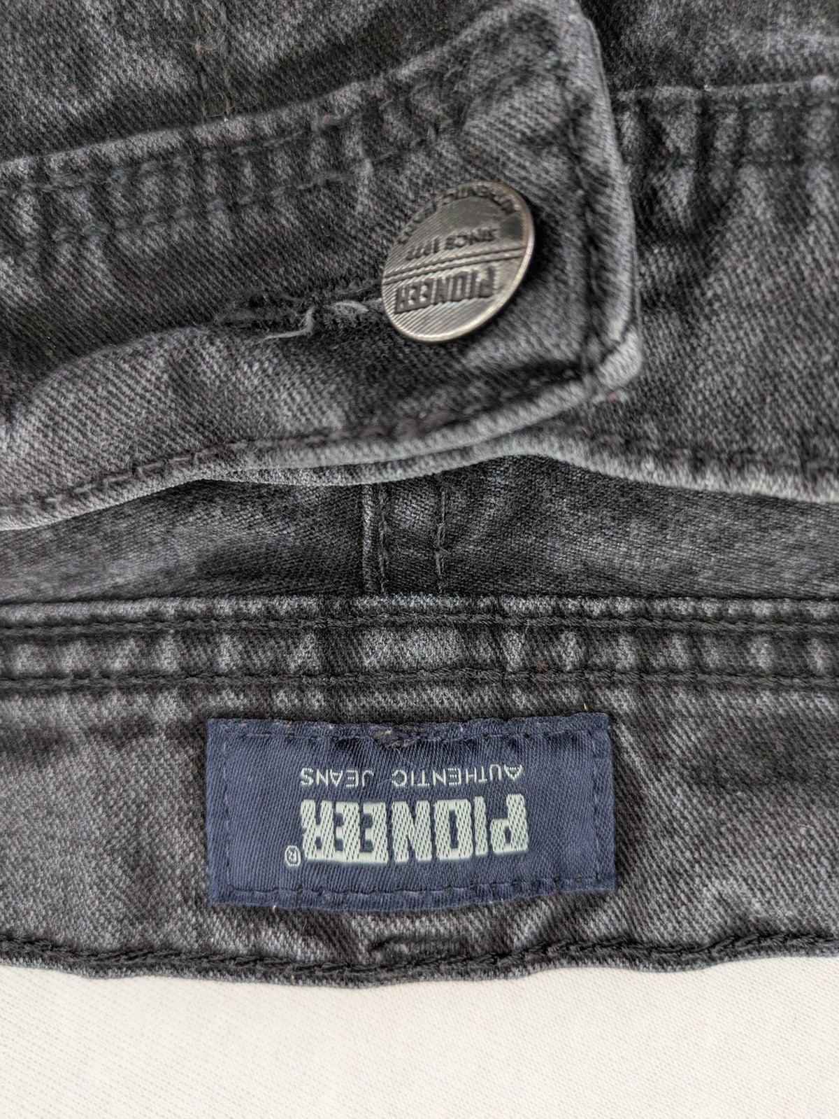 Pioneer grey straight jeans with washed finish and stretch material, classic design.