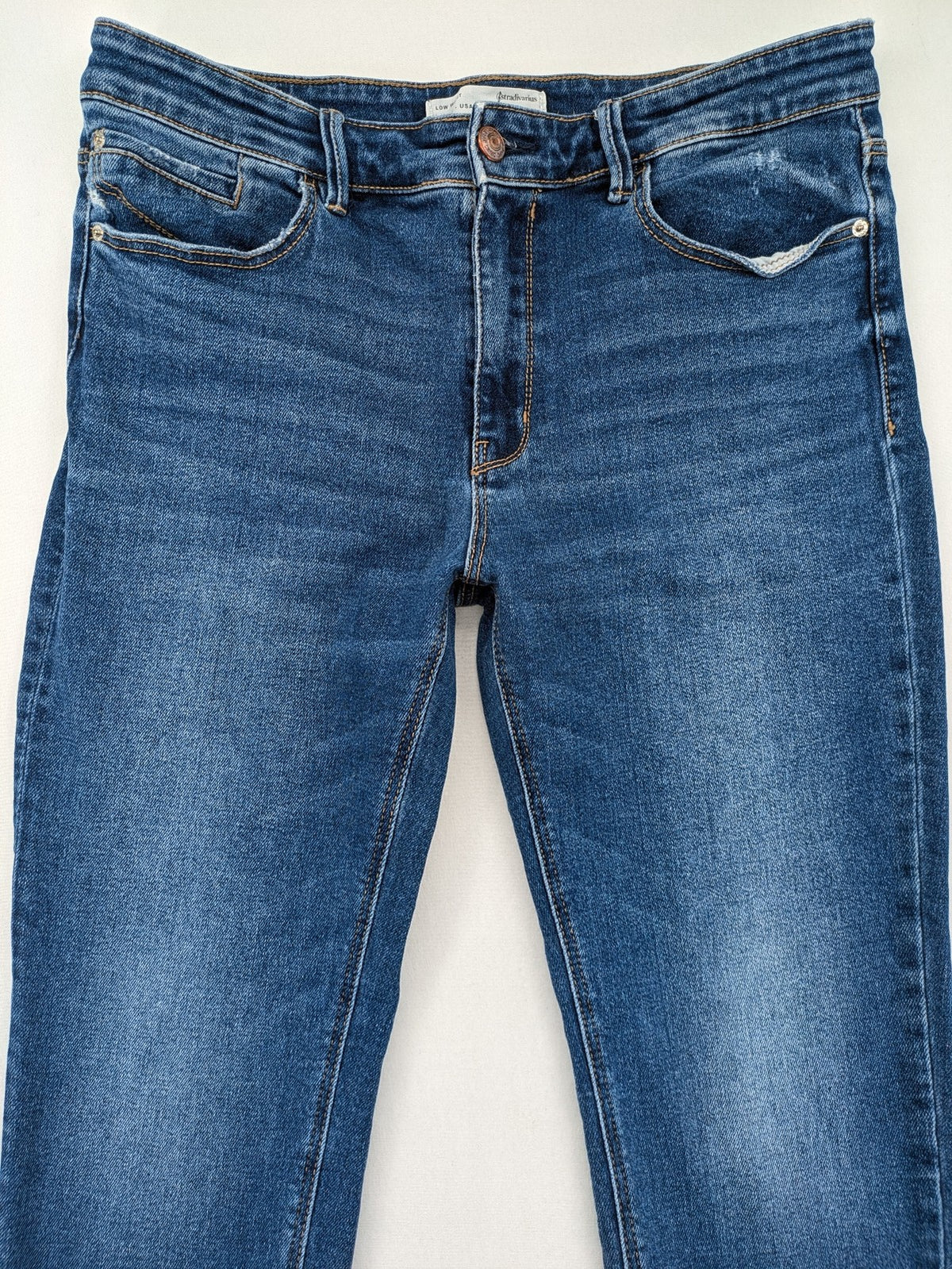 Stradivarius blue low waist skinny jeans with subtle fading and classic denim texture.