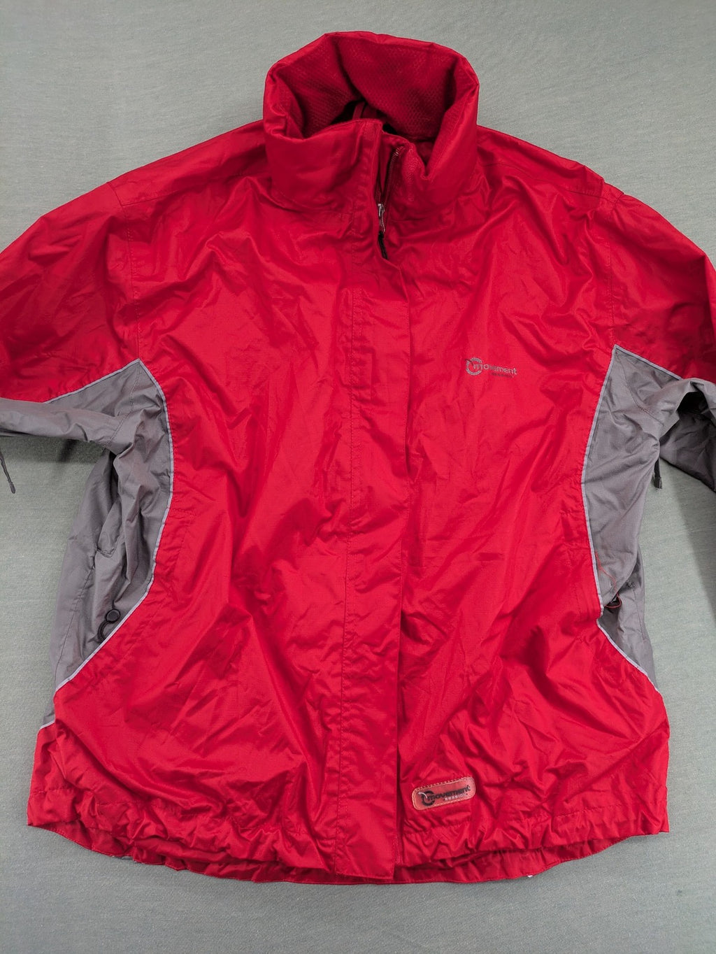 Movement Session grey and red windbreaker jacket with colorblock pattern and full zip.