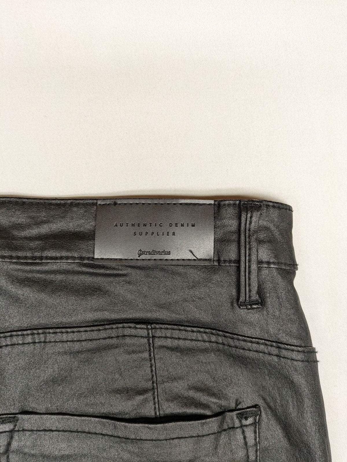 Stradivarius black coated straight jeans with leather-like finish and stretchy material.