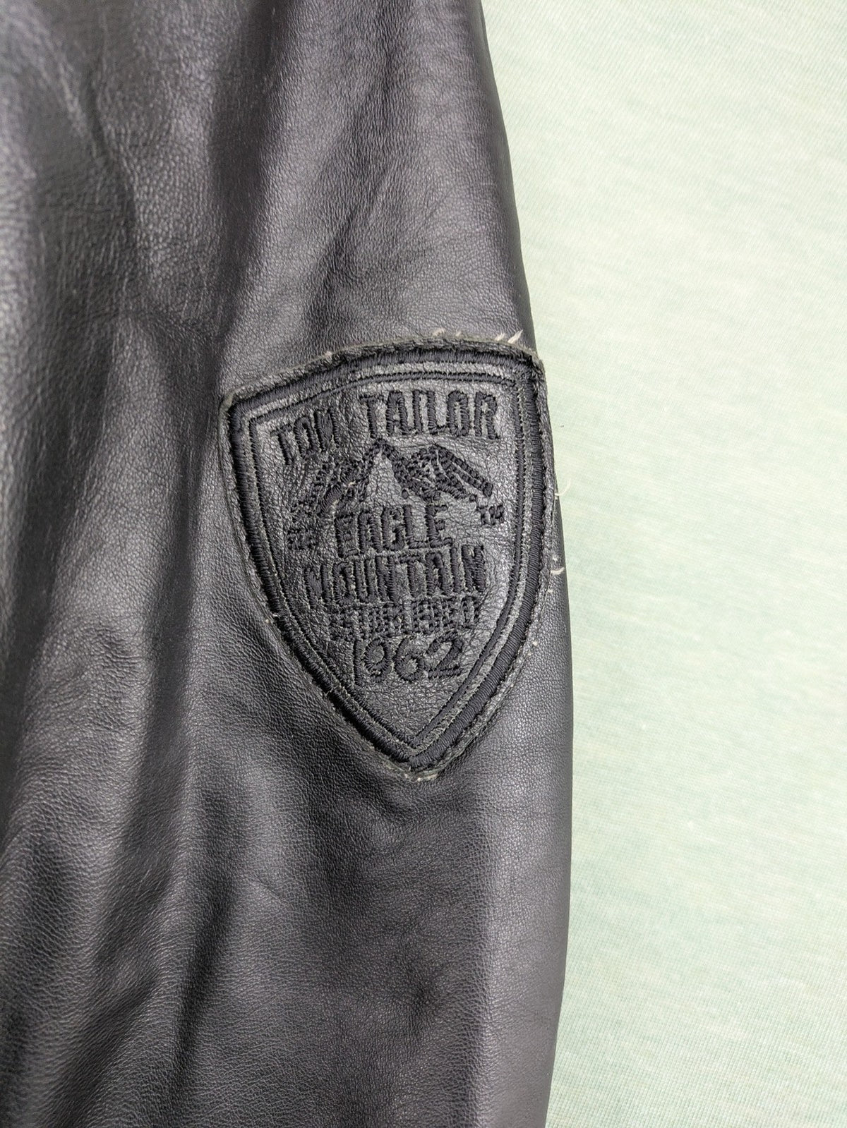 Tom Tailor black leather jacket vintage style with multiple pockets and contrast stitching.