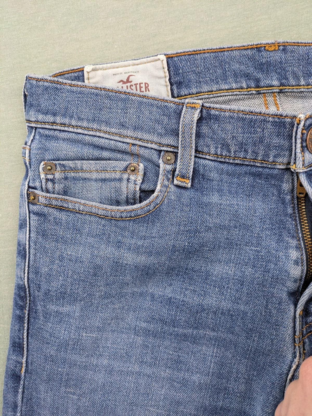 Hollister blue slim fit jeans with classic 5-pocket design and stretch denim material.