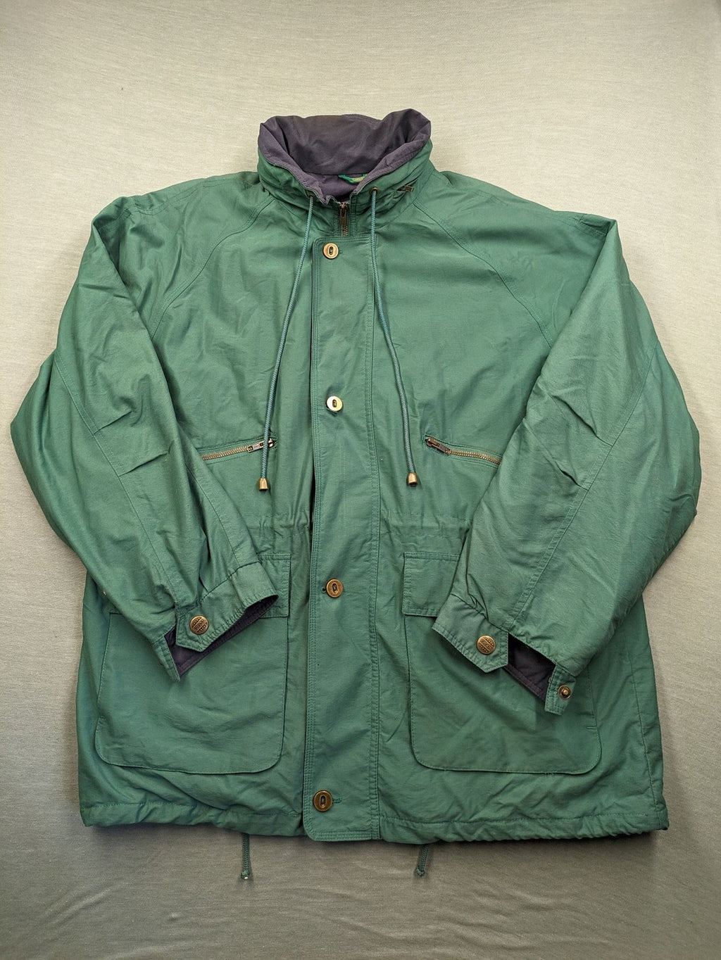 Canda green parka coat with dark lining, multiple pockets, and Micro Membrane technology.