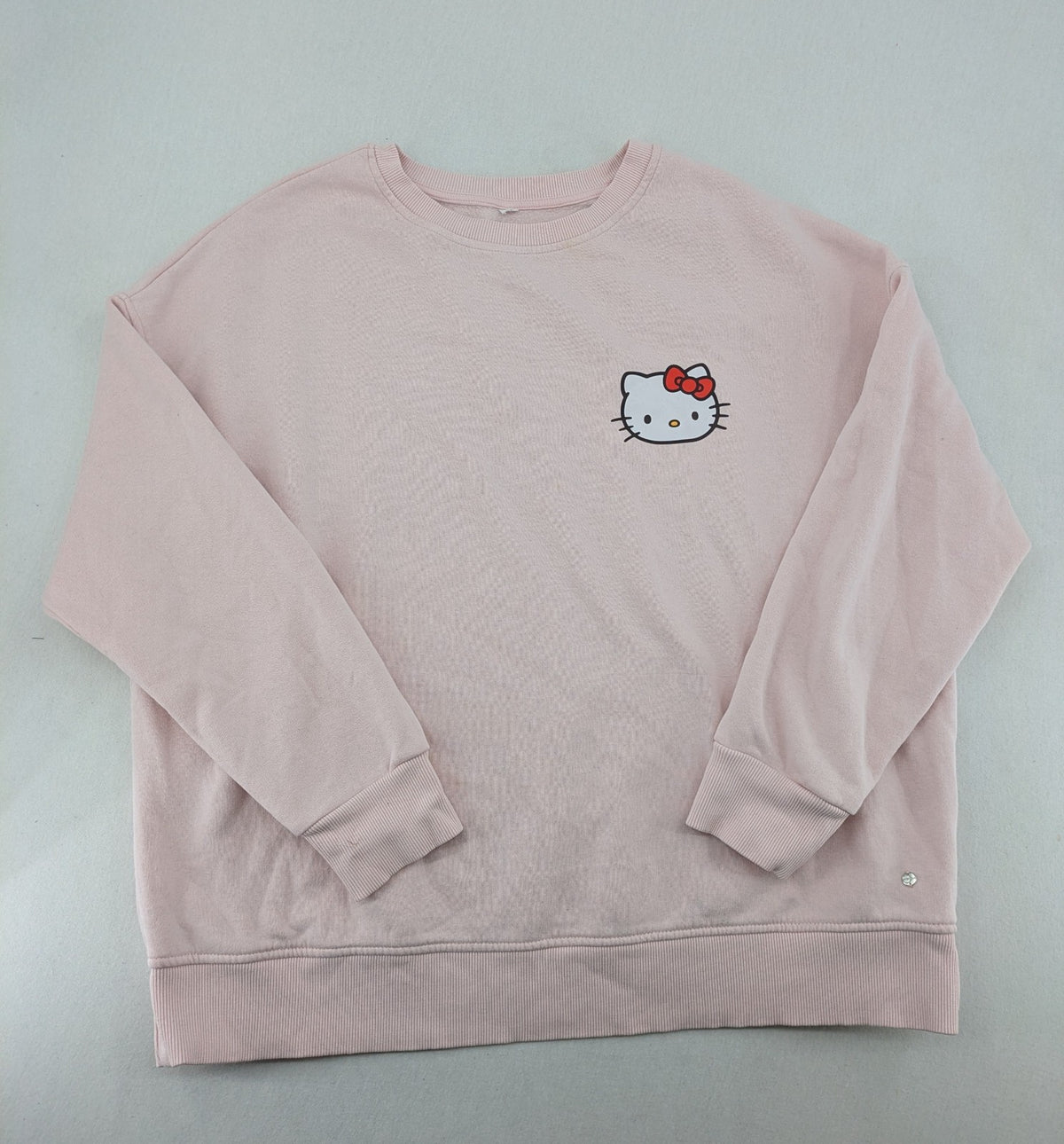 Hello Kitty pink sweatshirt classic graphic face logo on chest, long sleeves, round neck.