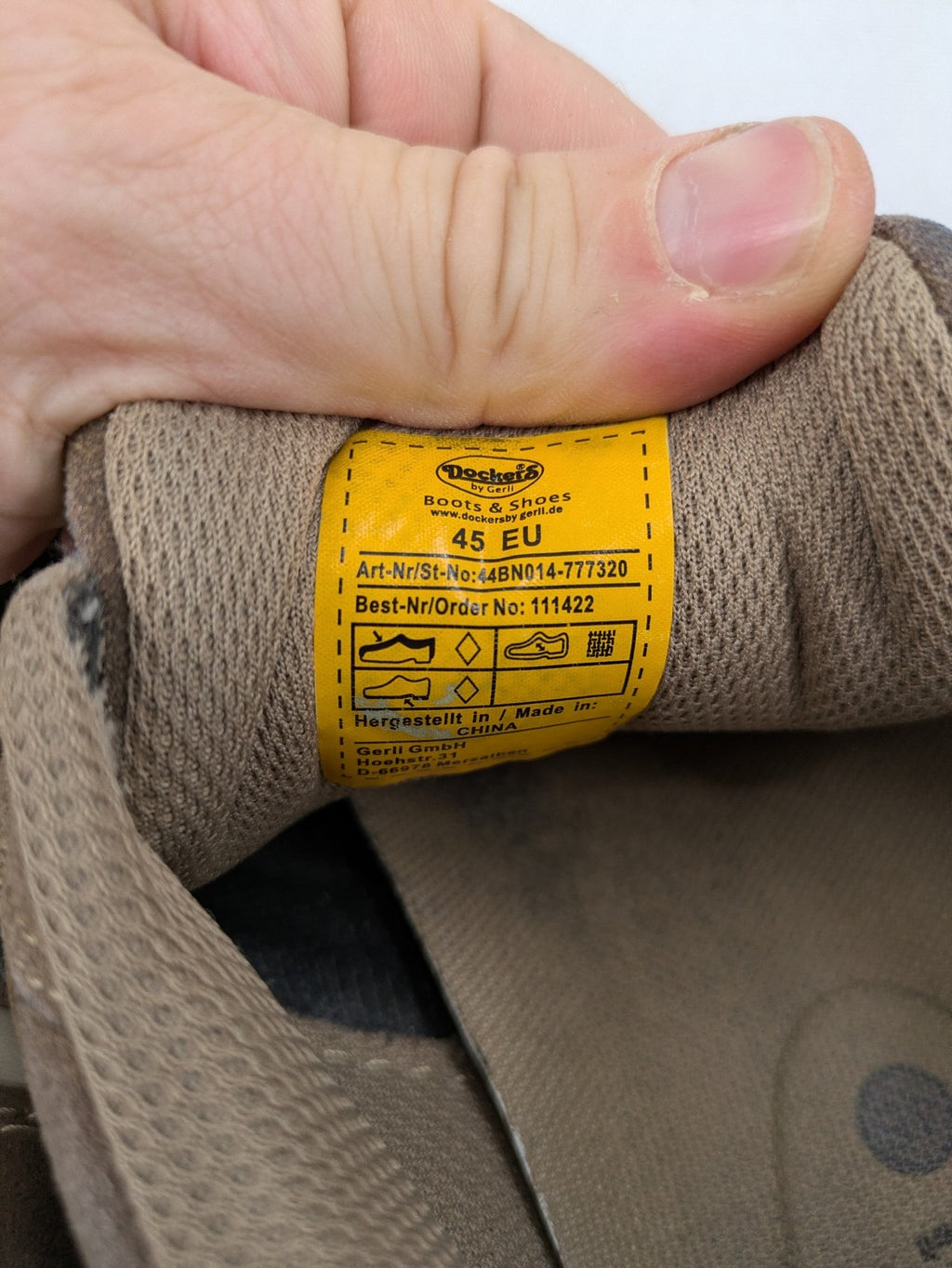 Dockers brown sneakers with subtle light brown and blue accents, lace-up design.