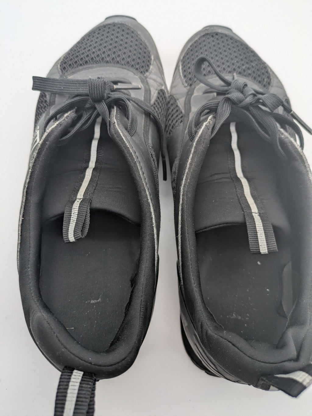 EA7 Emporio Armani beige and black sneakers with prominent EA7 branding and breathable mesh details.