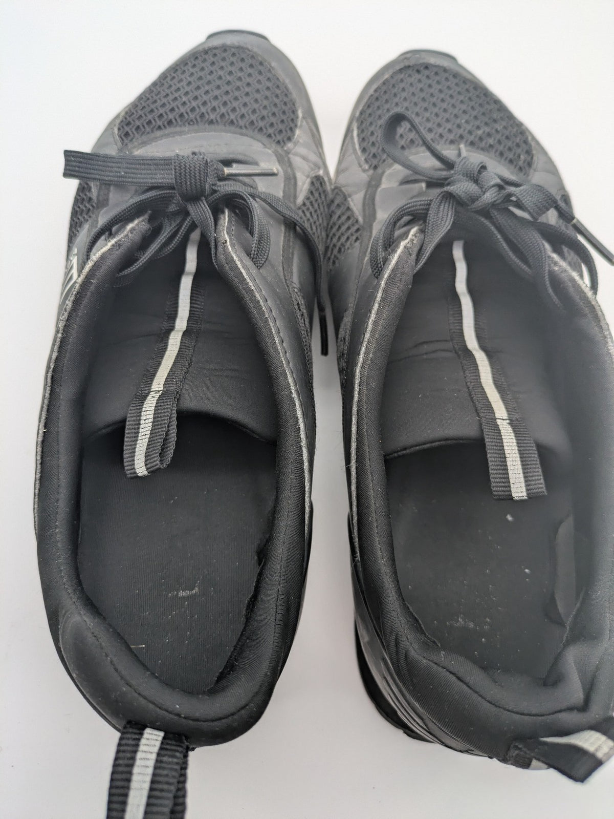 EA7 Emporio Armani beige and black sneakers with prominent EA7 branding and breathable mesh details.