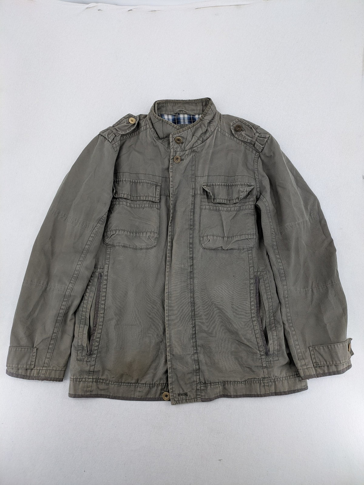 Walbusch khaki military jacket with checkered blue-white lining and multiple pockets.