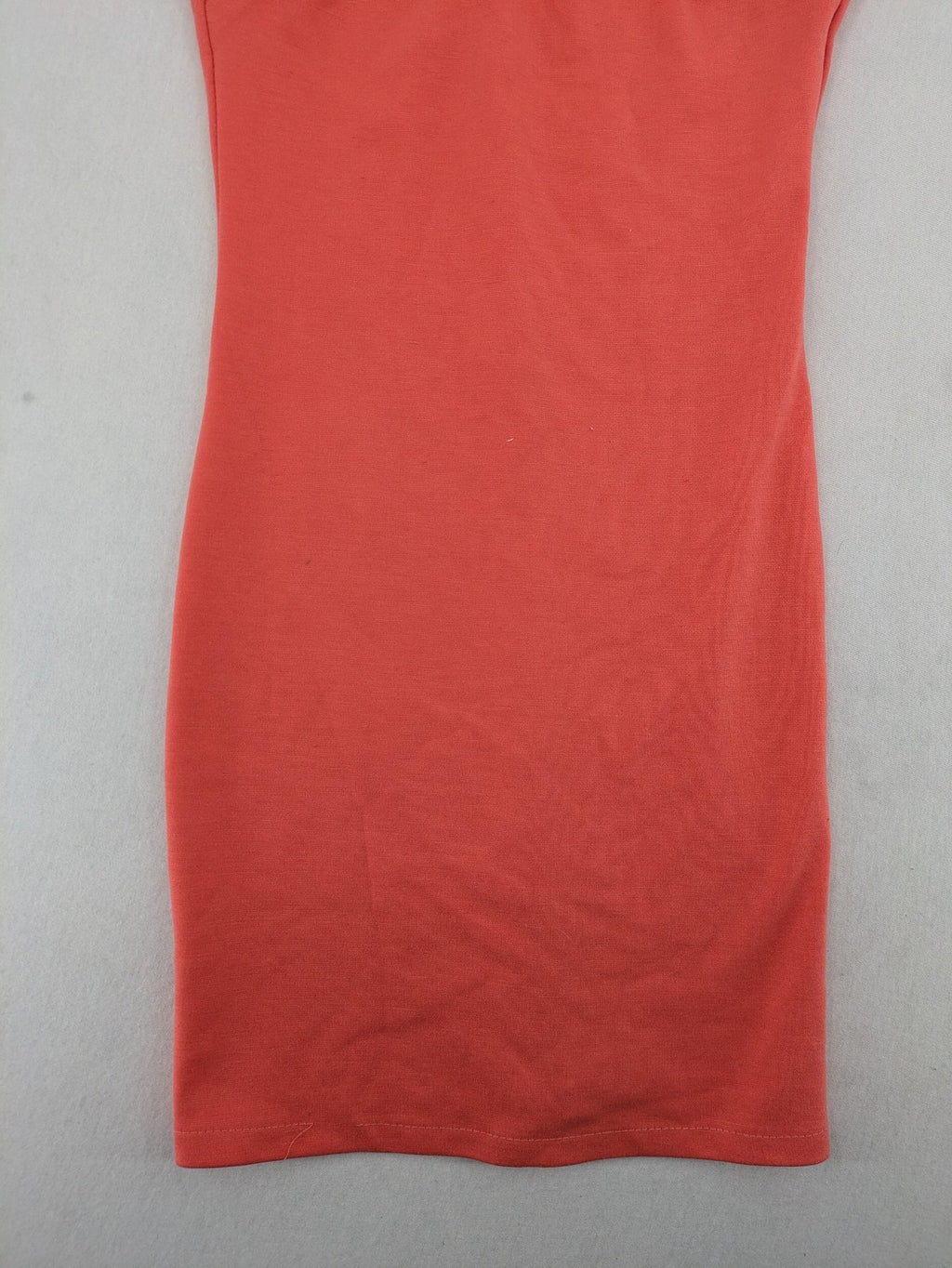 Zebra orange bodycon mini dress with deep V-neck and sleeveless design.