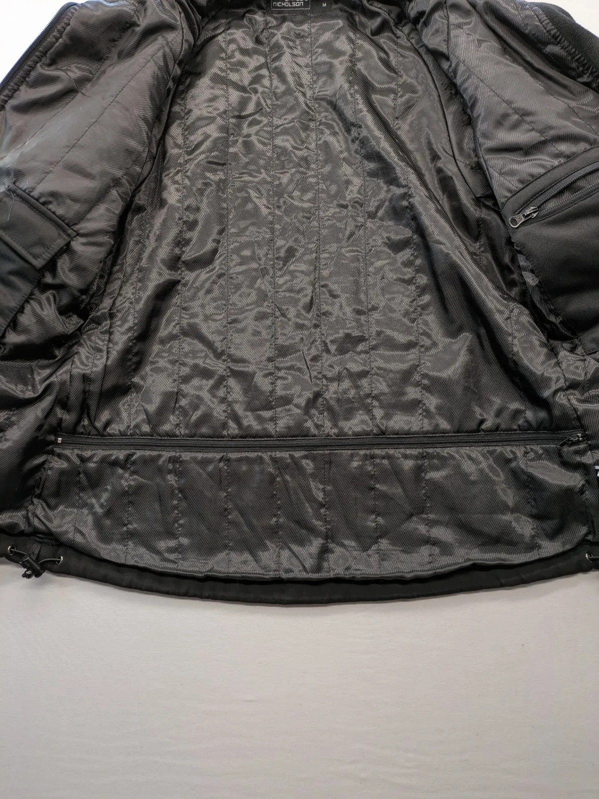 James & Nicholson grey softshell jacket with fleece lining and multiple zip pockets.