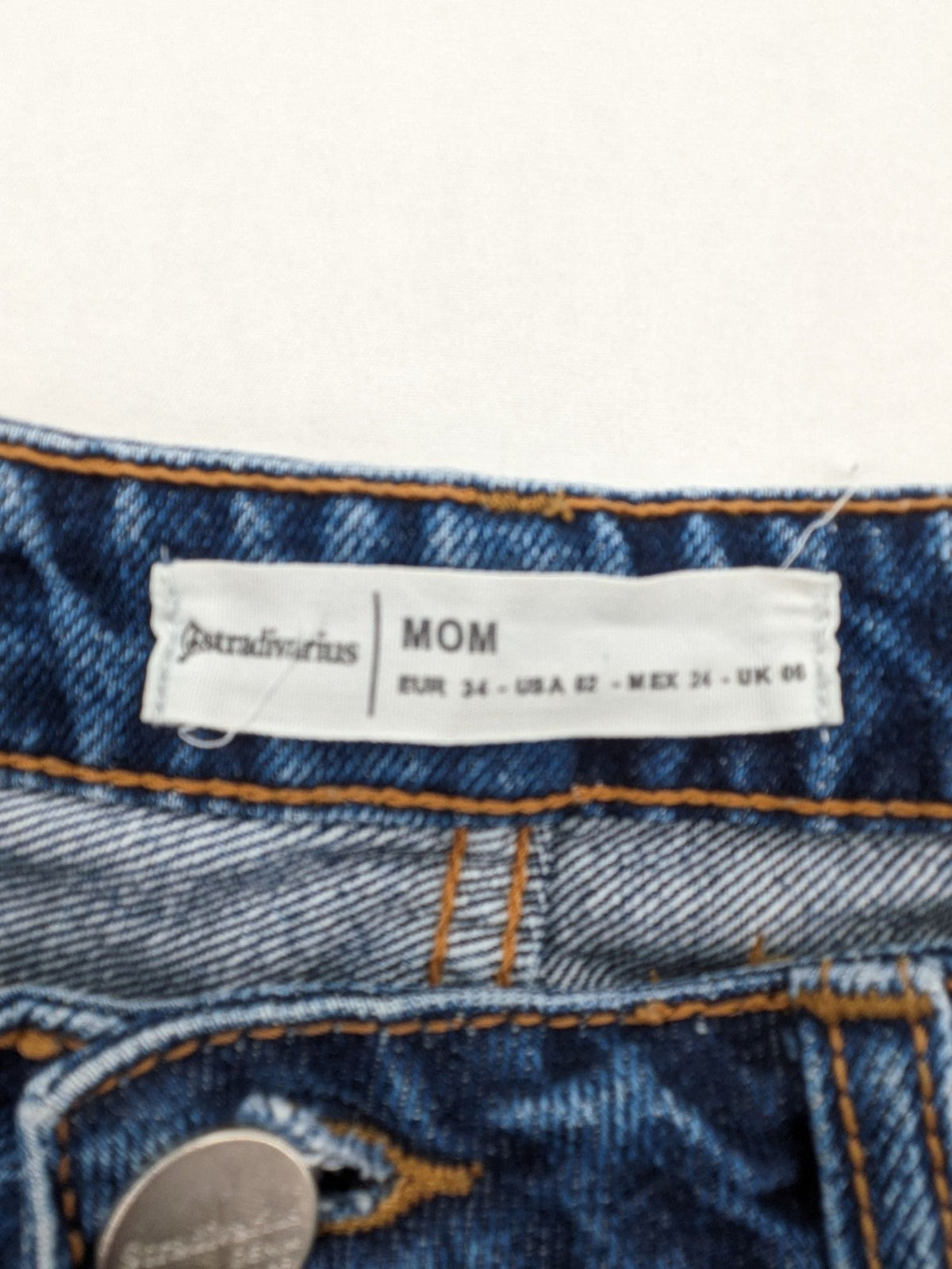 Stradivarius blue mom jeans high waist with button fly and classic denim texture.