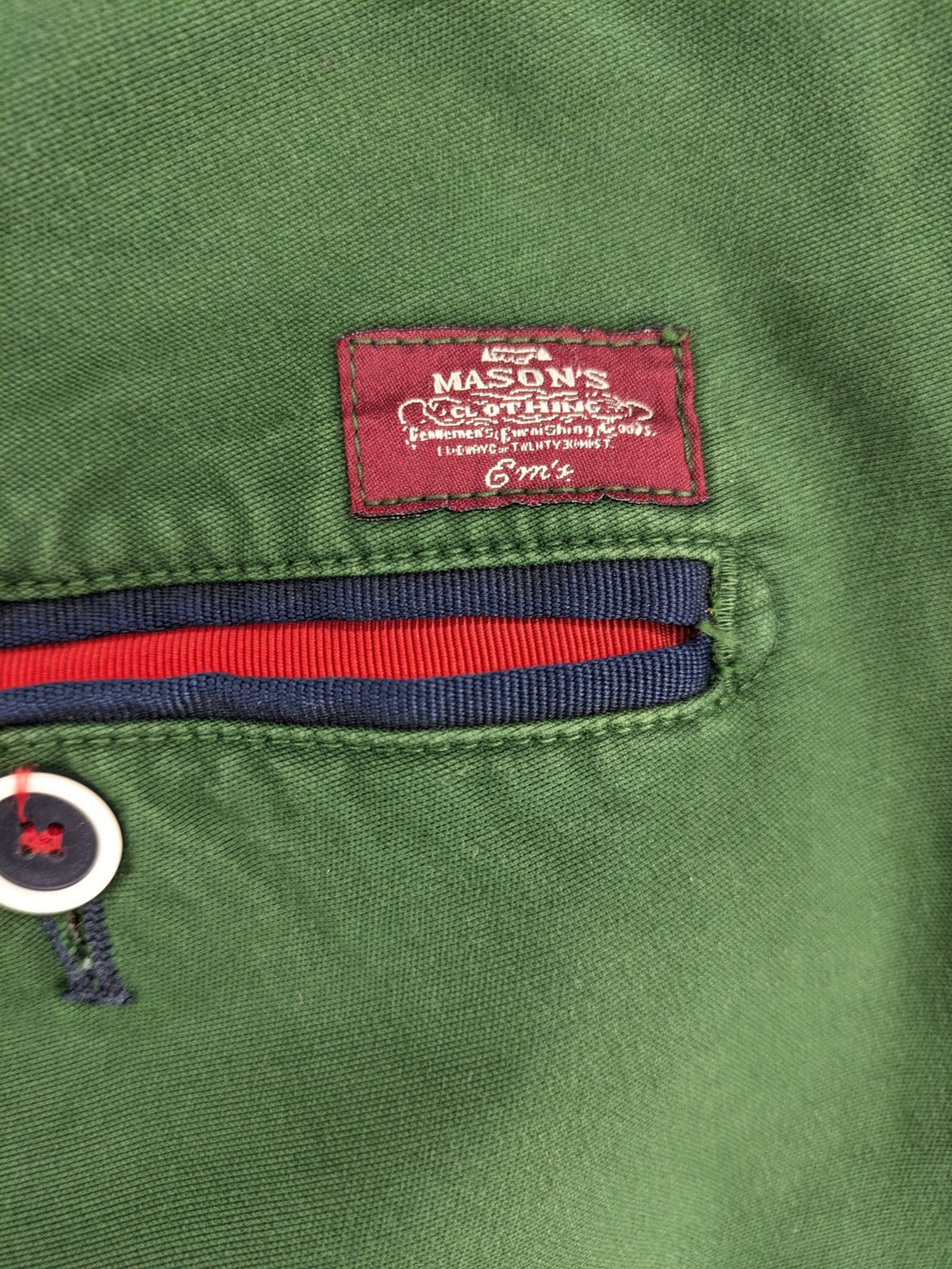 Mason's green chino pants with striped red and blue waistband, cotton stretch material.