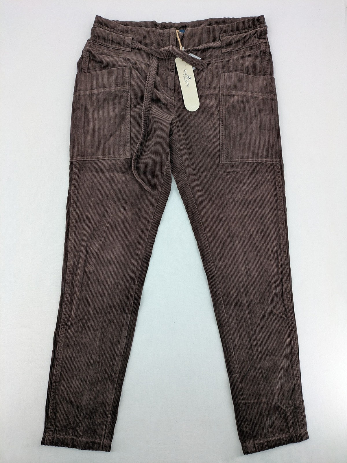Alma & Lovis brown cord pants with elastic waistband, drawstring, and front patch pockets.
