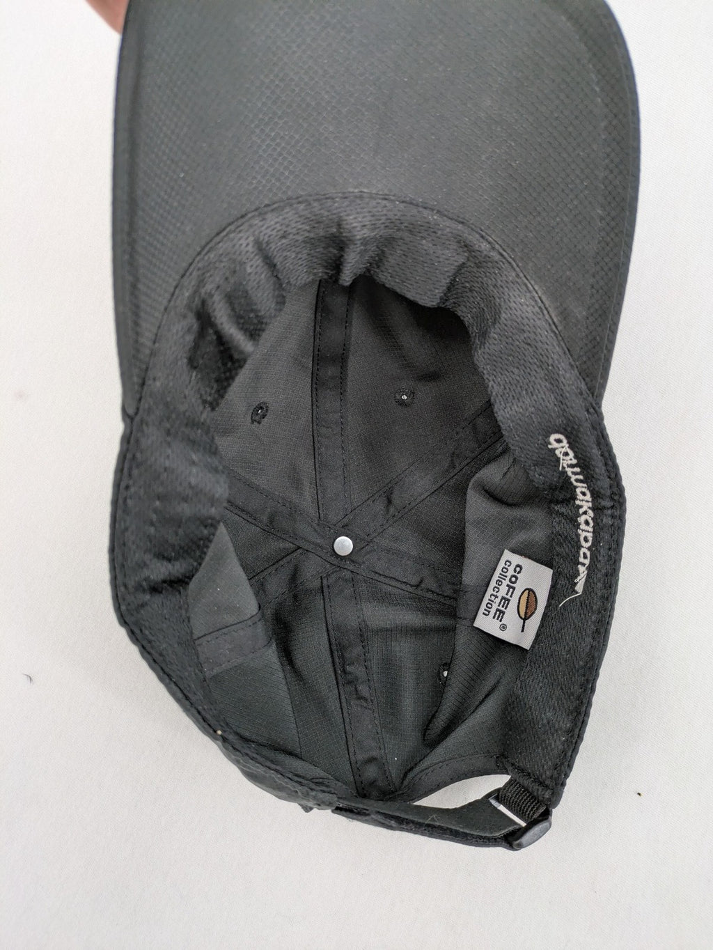 Dormakaba grey baseball cap 6-panel design with white embroidered logo and adjustable strapback.