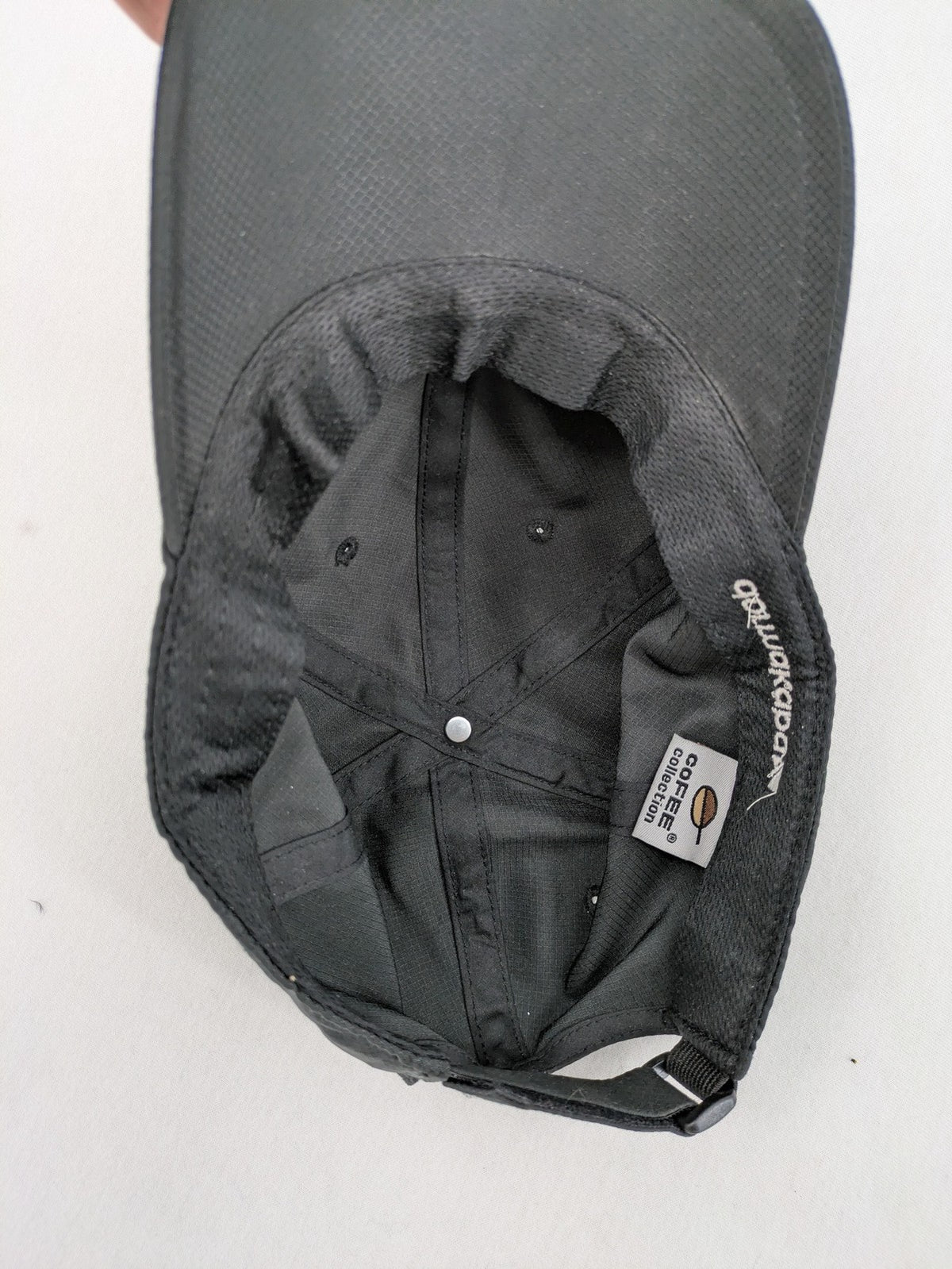 Dormakaba grey baseball cap 6-panel design with white embroidered logo and adjustable strapback.