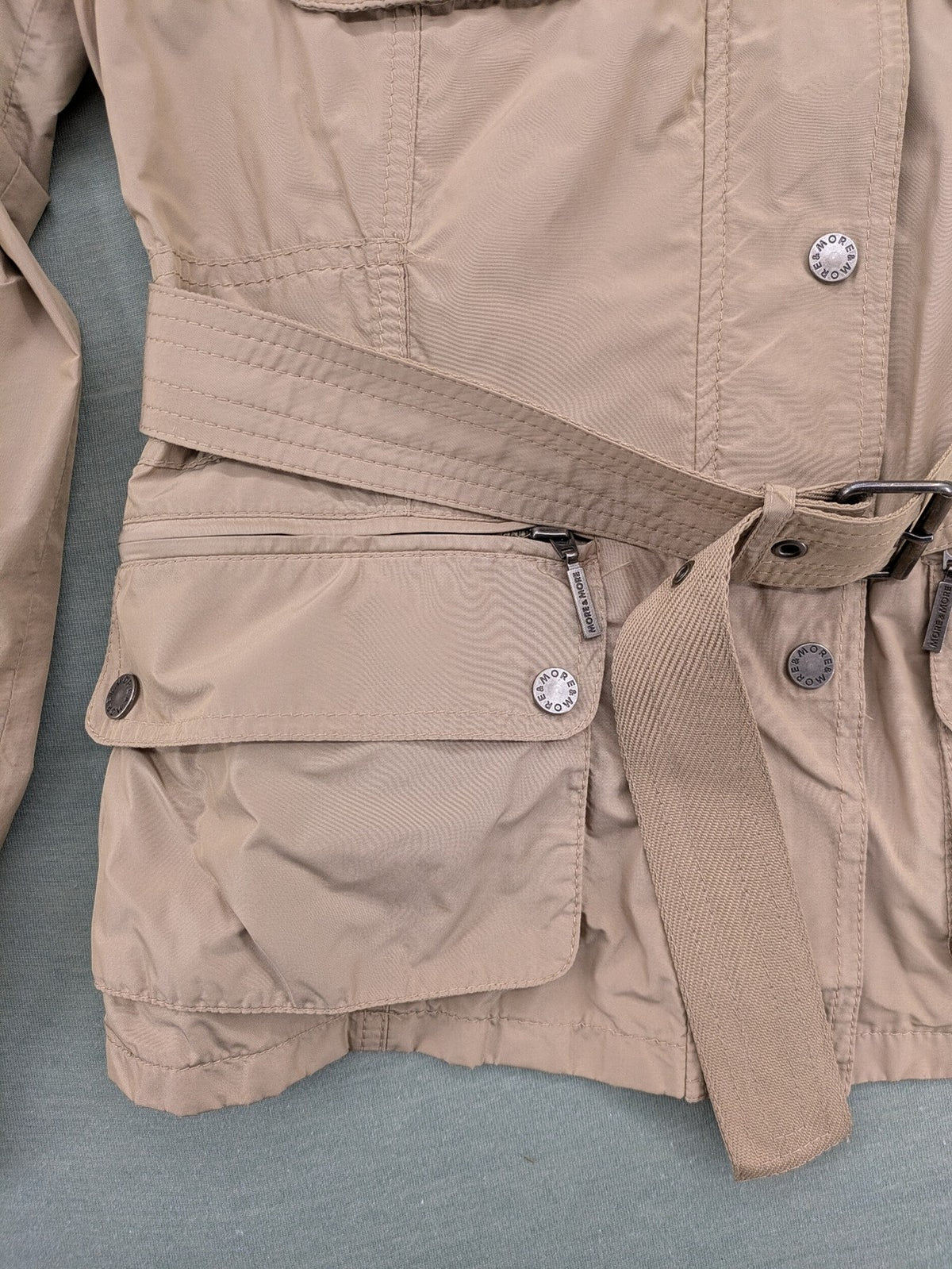 MORE & MORE beige field jacket with belt, four pockets, and standing collar.