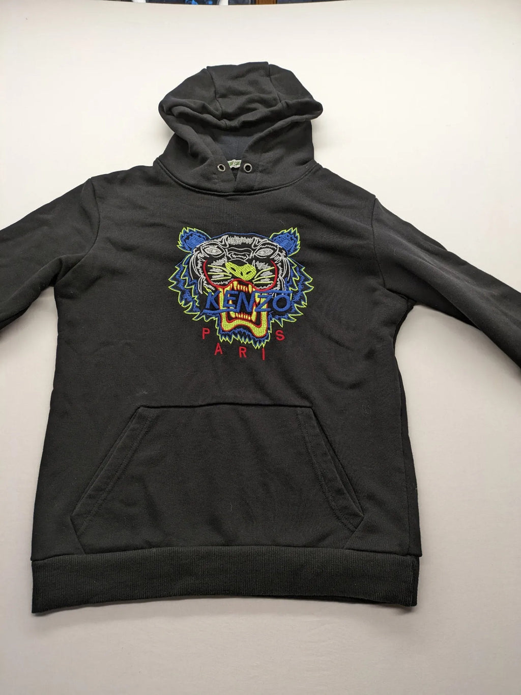 Kenzo multi hoodie with embroidered tiger graphic, drawstring hood, and kangaroo pocket.