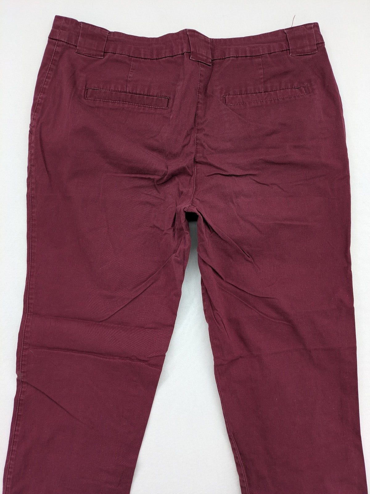 BPC Bonprix burgundy chino pants with front pleats and floral pocket lining.
