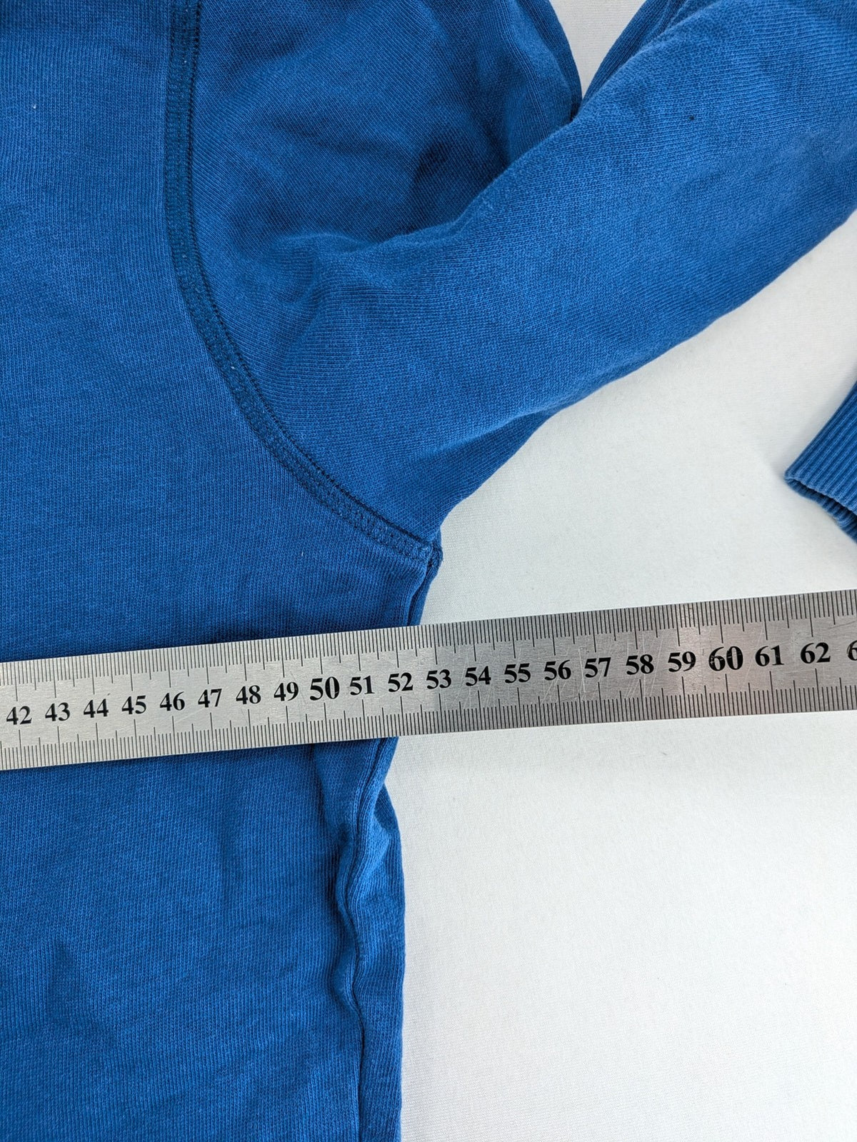 Converse All Star blue zip-through hoodie with red graphic logo and kangaroo pocket.