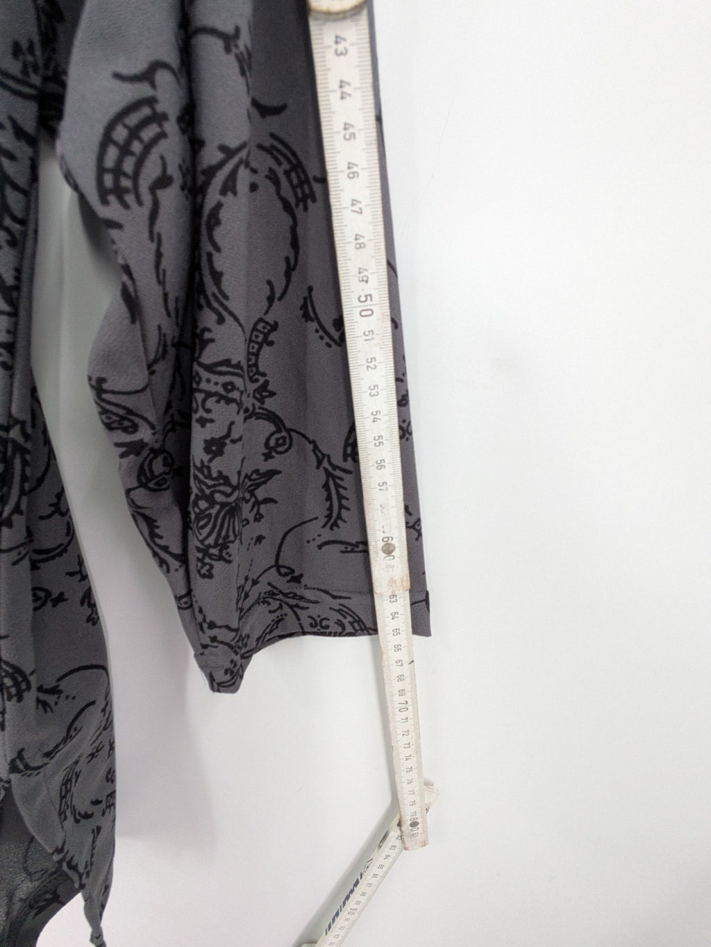 Yessica grey black floral pattern tunic top with round neckline and long sleeves.