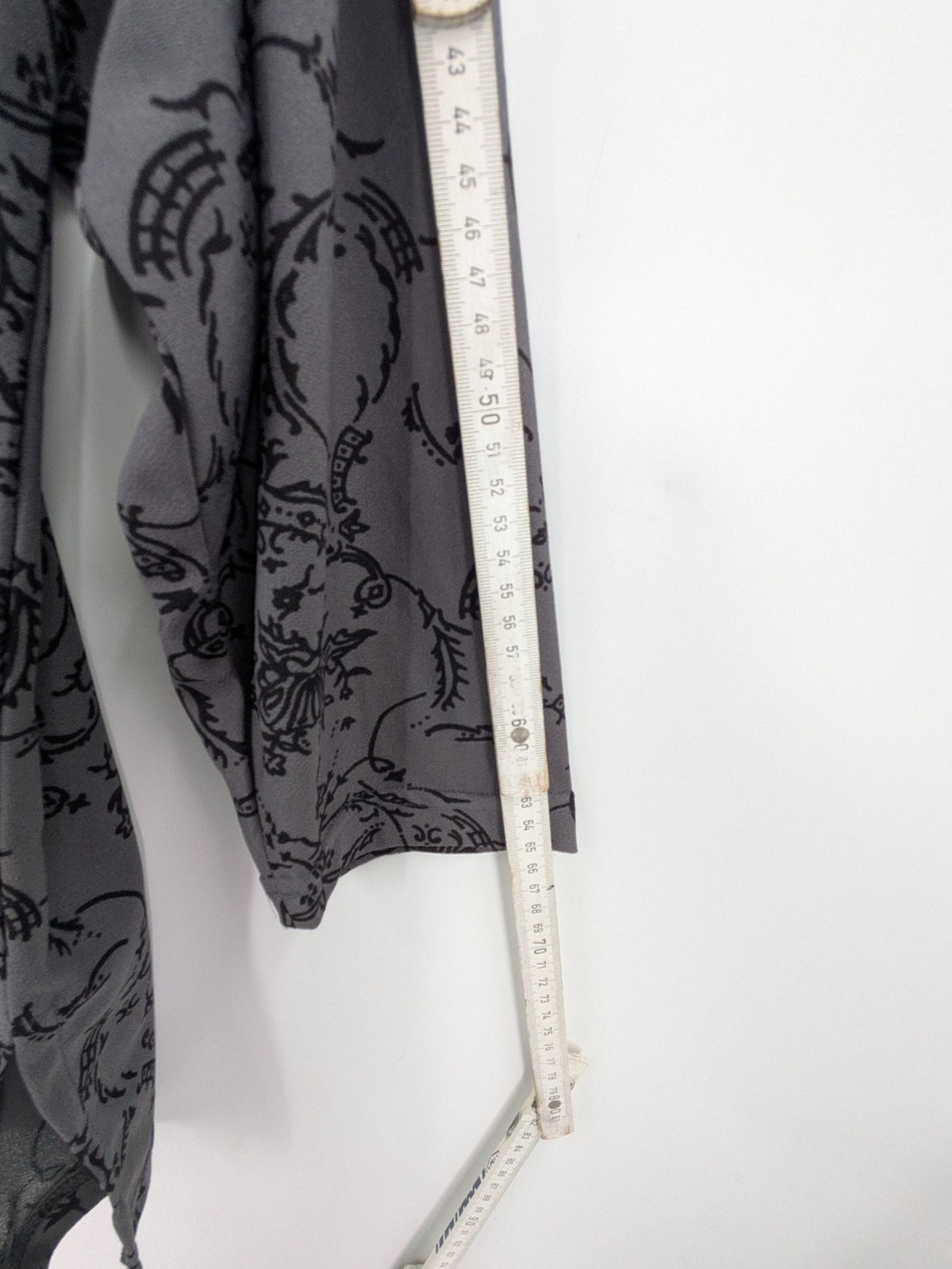 Yessica grey black floral pattern tunic top with round neckline and long sleeves.