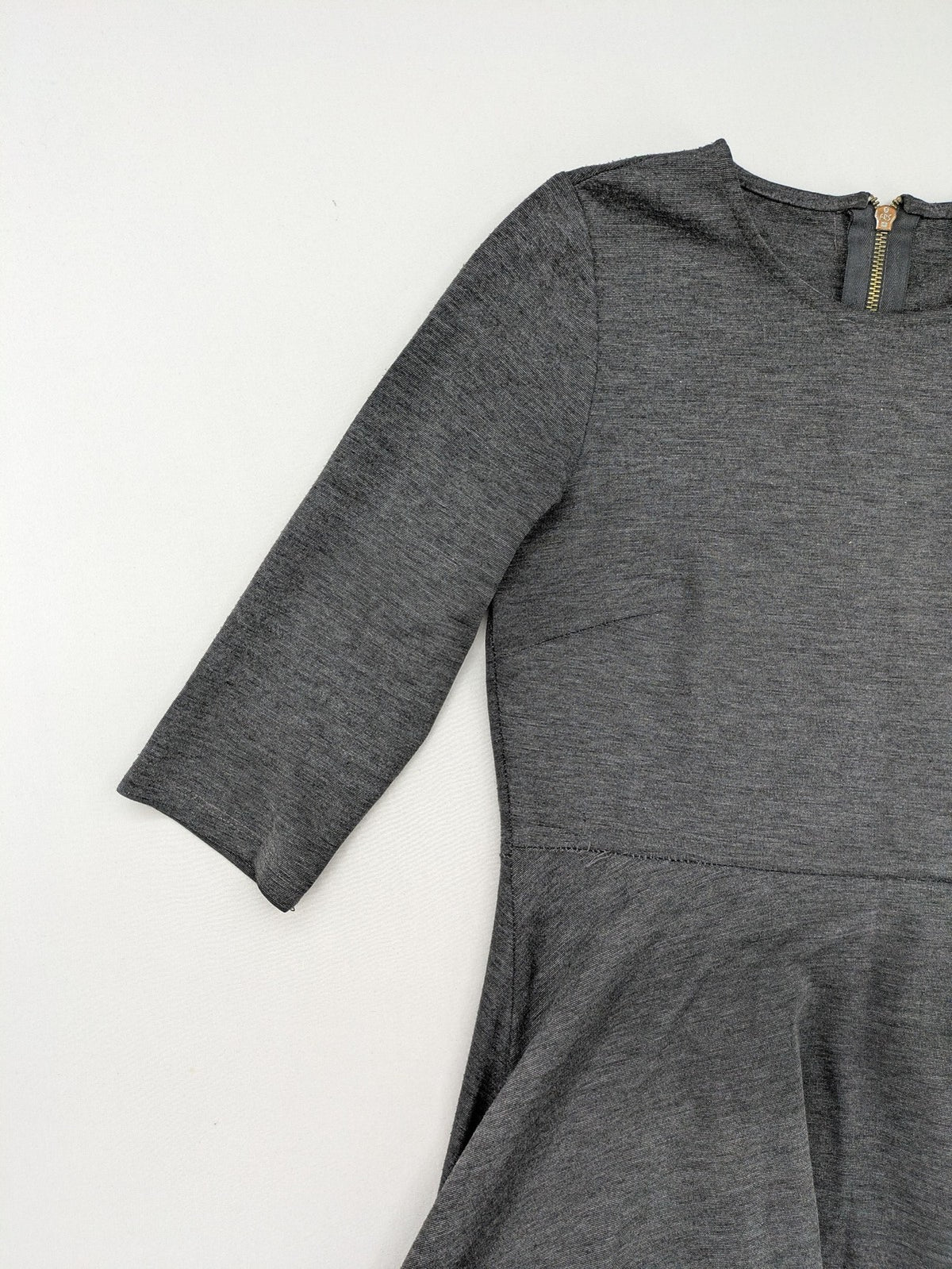 Ginatricot grey A-line skater dress with 3/4 sleeves and visible back zipper.