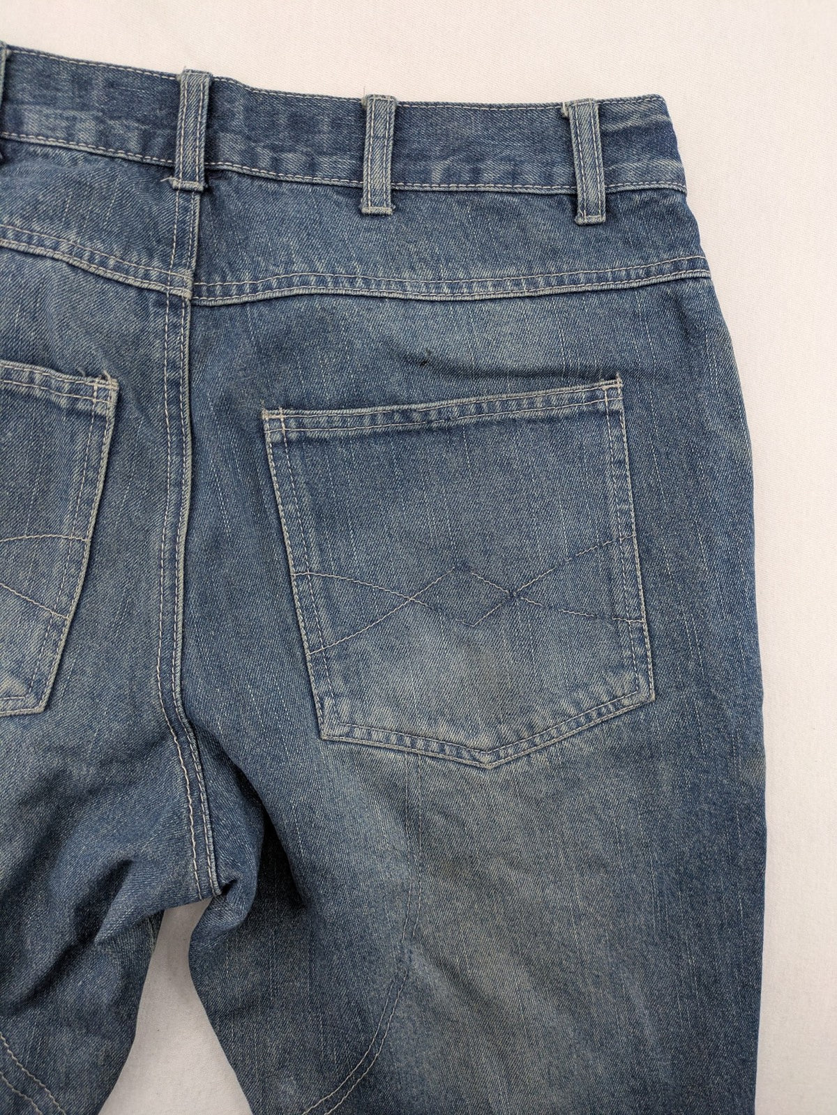 John F. Gee blue straight jeans with reinforced knees and durable denim material.